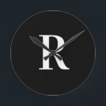 Simple Monogram Black and White Round Clock<br><div class="desc">This is a simple, modern, personalised monogram design. This stylish design is in classic black and white with stylish typography. It's perfect for a personalised gift or ideal as a new addition to your home decor. Simply add your initial letter by typing it into the personalise this text box. Check...</div>