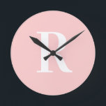 Simple Monogram Modern Blush Pink Round Clock<br><div class="desc">This is a simple, modern, personalised monogram design. This stylish design is in trending blush pink with stylish typography. It's perfect for a personalised gift or ideal as a new home decor accessory for yourself. Simply add your initial letter by typing it into the personalise this text box. Check out...</div>