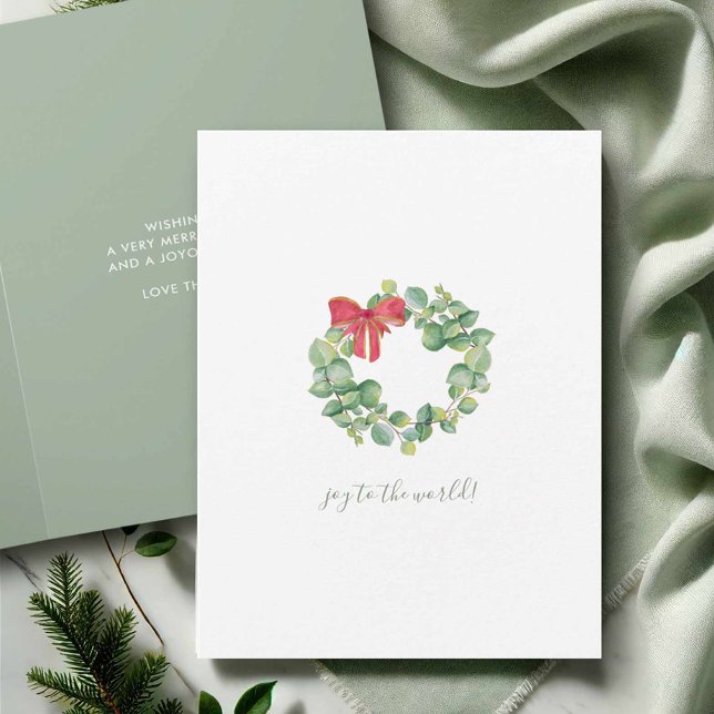 Simple Watercolor Botanical Wreath Christmas Card (Watercolor Christmas cards with wreath and red bow by Victoria Grigaliunas of Do Tell A Belle)