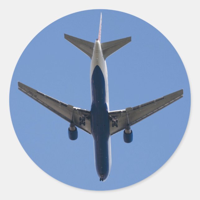 Single aeroplane on the blue sky background classic round sticker (Front)