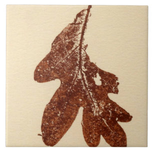 Single oak leaf nature printed in brown ink on tan tile