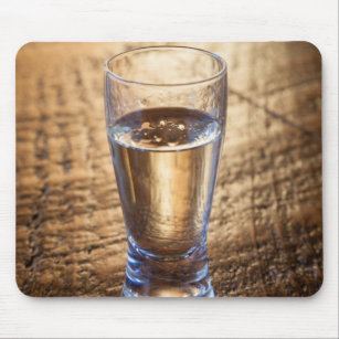 Single shot of Tequila on wood table Mouse Mat