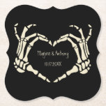 Skeleton Hands Heart Shape Custom Wedding Paper Coaster<br><div class="desc">Add a creepy, personalised touch to your wedding with these paper coasters. These disposable coasters are black and feature an illustration of skeleton hands in a heart shape framing the bride and groom's names and wedding date. The graphic and text are in a cream or ivory colour. The macabre style...</div>