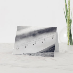 Skiers on a chair lift card