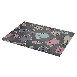 Skulls, and hearts on black background cutting board