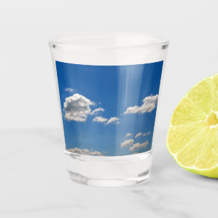 Sky is blue and white clouds are passing by shot glass