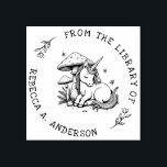 Sleeping Unicorn Toadstool Bookplate Stamp<br><div class="desc">Enchant your library with this personalised book stamp featuring a sleeping baby unicorn nestled beneath a magical toadstool. Surrounded by delicate ferns and fluttering butterflies,  this whimsical design adds a fairytale charm to every book. A dreamy gift for readers,  kids,  and lovers of fantasy and woodland magic.</div>