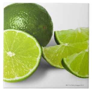 Sliced lime wedge, on white background, cut out tile