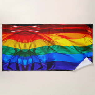 SlipperyJoe's gay pride flag waving pride colors v Beach Towel
