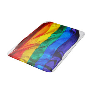 SlipperyJoe's gay pride flag waving pride colours Bath Mat