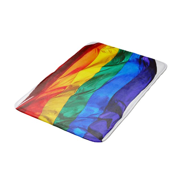SlipperyJoe's gay pride flag waving pride colours  Bath Mat (Angled)