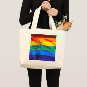 SlipperyJoe's gay pride flag waving pride colours  Large Tote Bag