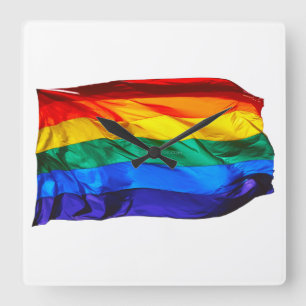 SlipperyJoe's gay pride flag waving pride colours Square Wall Clock