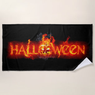 SlipperyJoe's Happy Halloween pumpkin glowing eyes Beach Towel