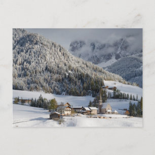 Small alpine village in the snow postcard