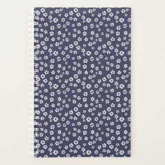 Small white flowers on a blue planner