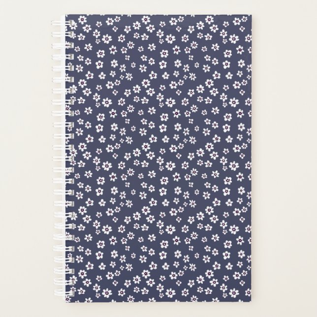 Small white flowers on a blue planner (Front)