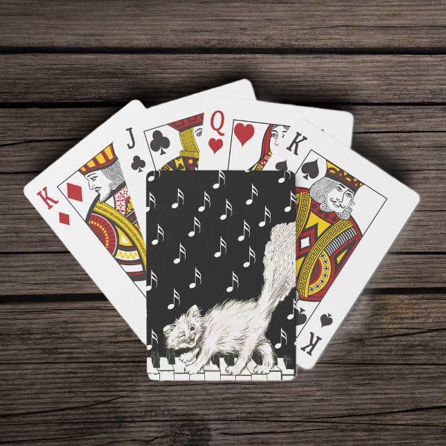 Smiling Winking Fluffy White Cat on Piano Playing Cards (Smiling white cat walking across piano keys music notes on black white deck of playing cards.)