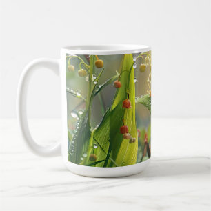 Snail with dew in the grass coffee mug
