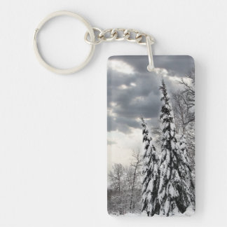 Snow-Covered Evergreen Trees Under Dramatic Winter Key Ring