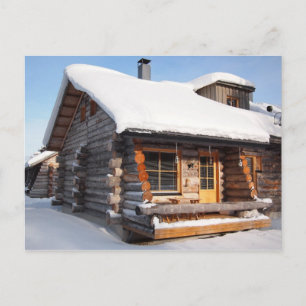 Snow-covered log cabin in Lapland postcard