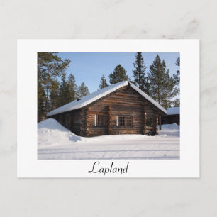 Snow-covered log cabin in Lapland text postcard
