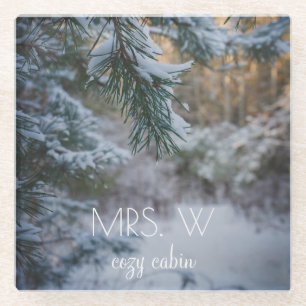 Snow-covered pine branches glass coaster
