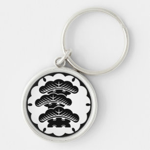 Snow-covered three-tiered pine in rice cake key ring