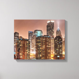 Snow falls over skyline at evening in Chicago Canvas Print