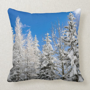 Snow trees under a clear blue sky cushion