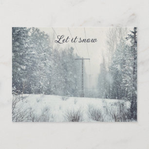 Snowfall in the winter forest holiday postcard