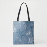 Snowflakes on a blue background tote bag<br><div class="desc">Snowflakes on a blue background Tote Bag - A two sided rugged tote with two snowflake scenes one on each side. The dark blue background is identical and so are the snowflakes but one side has a larger print, so the snowflakes are just a bit bigger. This bag would be...</div>