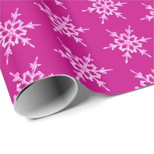Snowflakes, pale pink crystals on magenta wrapping paper