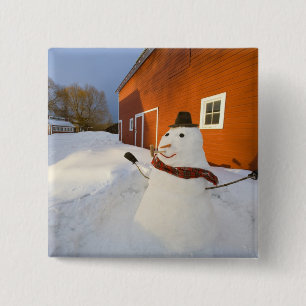 Snowman in front of red barn in Columbia Falls 15 Cm Square Badge
