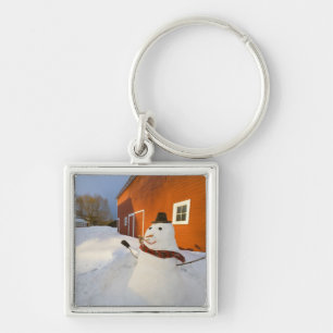 Snowman in front of red barn in Columbia Falls Key Ring