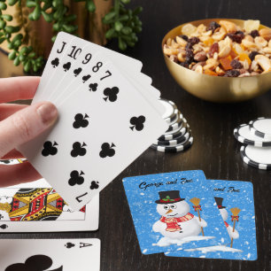 Snowman stands while snow falls playing cards