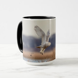 Snowy owl taking off mug