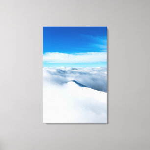 Snowy winter mountain wrapped in clouds canvas print