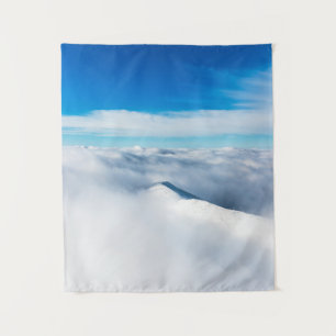 Snowy winter mountain wrapped in clouds tapestry