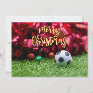 Soccer ball with Christmas decoration on green     Holiday Card