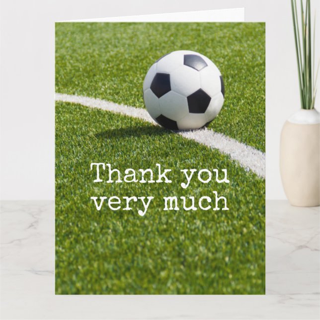 Soccer ball with word Thank you on green grass (Front)