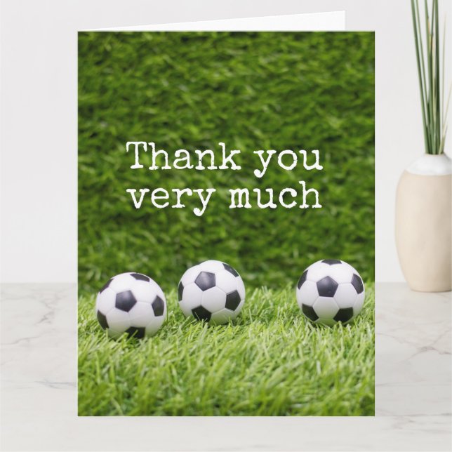 Soccer ball with word Thank you on green grass (Front)