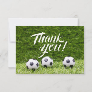 Soccer ball with word Thank you on green grass