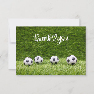 Soccer balls are on green grass thank you card