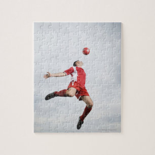 Soccer player and soccer ball in mid-air jigsaw puzzle