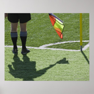 Soccer referee holding flag. poster