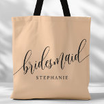 Soft Peach Bridesmaid Modern Script Tote Bag<br><div class="desc">Show your appreciation to your bridal party with this stylish soft peach bridesmaid tote bag. Featuring modern script and customisable with your bridesmaid's name, this tote bag is both practical and elegant. The soft colour and chic design make it perfect for carrying wedding day essentials or everyday items. This personalised...</div>