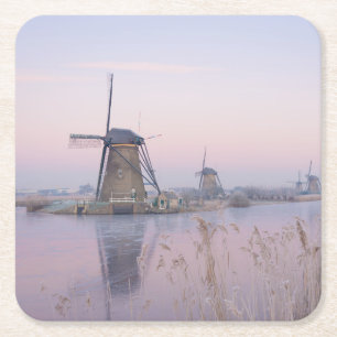 Soft sunrise light in winter over windmills square paper coaster