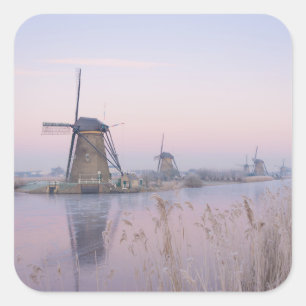 Soft sunrise light in winter over windmills square sticker