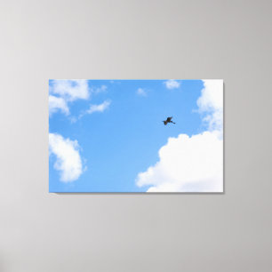 Solitary Bird Soaring Through Bright Blue Sky with Canvas Print